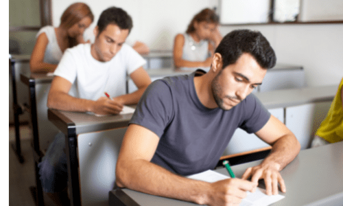 An examination in progress where students are sat in rows 